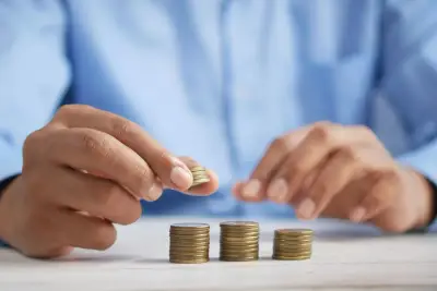 Stacking coins representing accumulating BIR penalty surcharge and interest for late freelancer registration in Davao