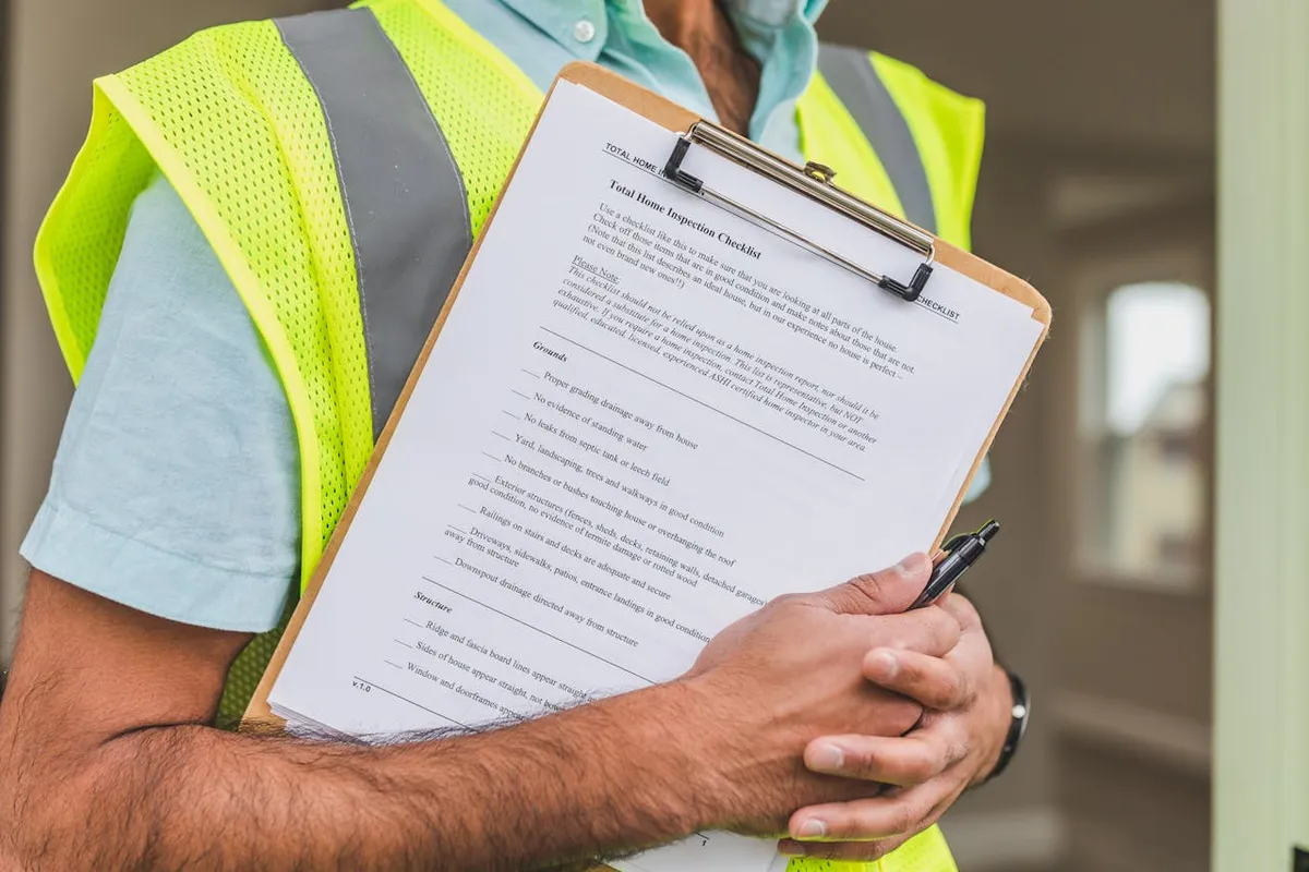 Home inspection checklist on a clipboard for apartment viewing