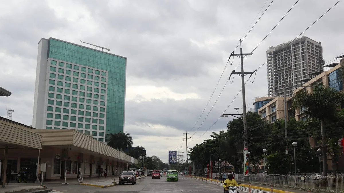 Mid-rise and high-rise buildings along a main avenue in central Davao