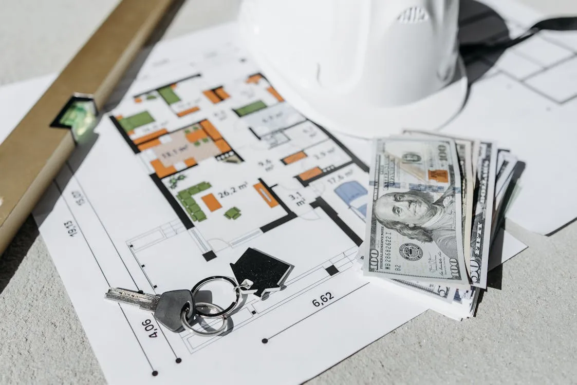 Apartment keys, peso bills, and a floor plan on a wooden desk representing a Davao rent negotiation