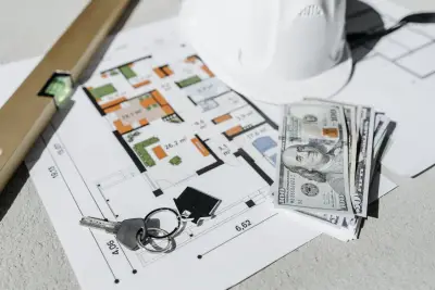 Apartment keys, peso bills, and a floor plan on a wooden desk representing a Davao rent negotiation