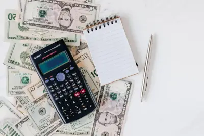 Calculator and Philippine peso bills for computing Davao freelancer service invoice totals post-EOPT